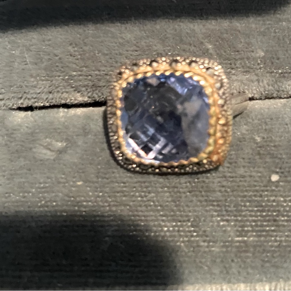 Multi faceted violet colored blue topaz ring